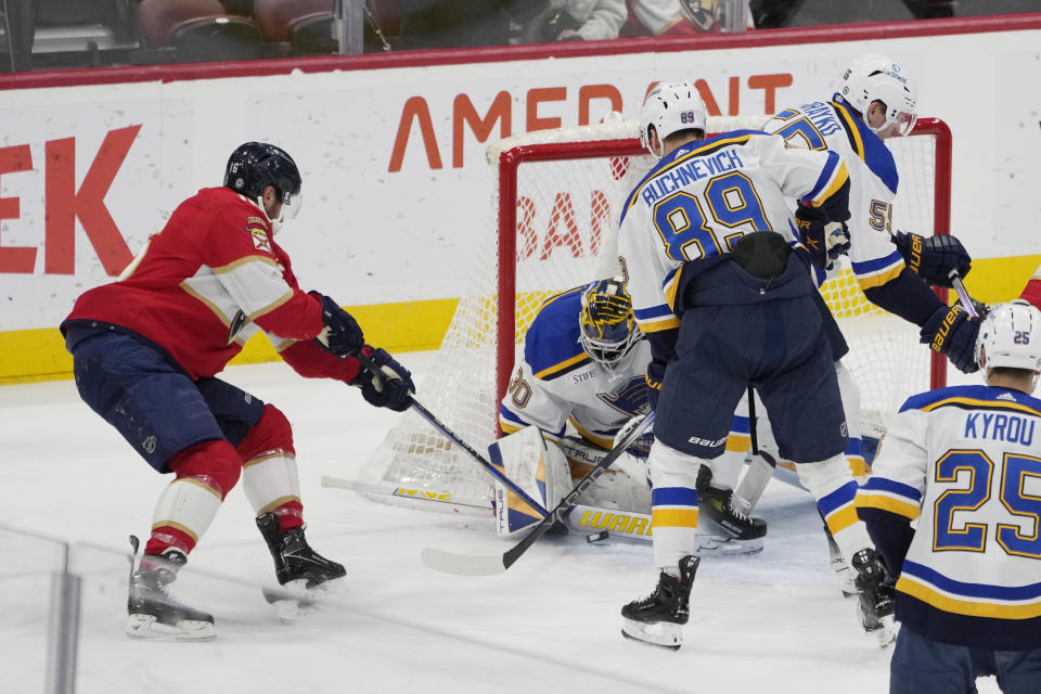 St. Louis Blues goaltender Joel Hofer (30) stops a shot by Florida Panthers center Aleksander Barkov (16) during the first period of an NHL hockey game, Thursday, Dec. 21, 2023, in Sunrise, Fla. (AP Photo/Marta Lavandier)