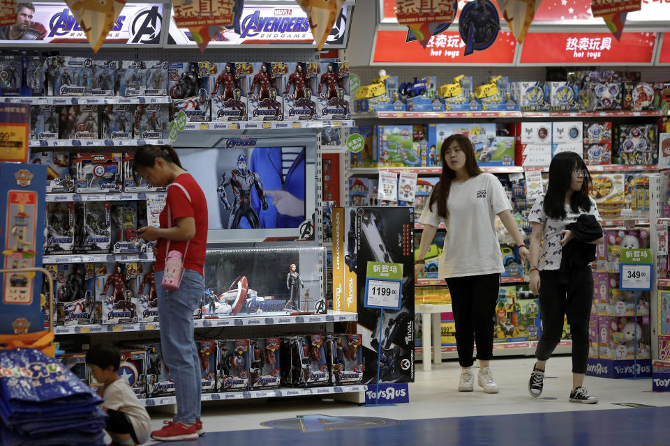 FILE - In this May 23, 2019, file photo, customers shop near a section selling Marvel Avengers toys by American toymaker Hasbro at a toy store in Beijing. The nation's business economists think President Donald Trump's trade war with China will contribute to a sharp slowdown in economic growth this year and next, raising concerns about a possible recession starting late next year. (AP Photo/Andy Wong, File)