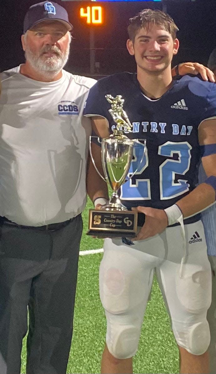 Cincinnati Country Day athletic director and football coach Dennis Coyle (left) and his son Ryan (right) after beating Summit Country Day in the 2023 Country Day Cup.