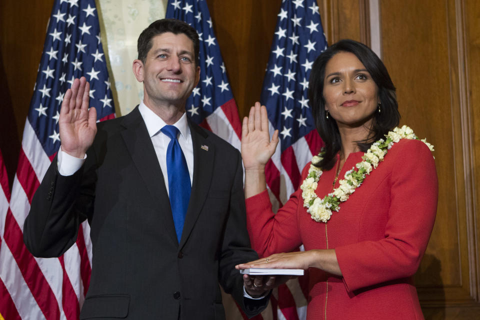 FILE--In this Jan. 3, 2017, file photo, House Speaker Paul Ryan of Wis. administers the House oath of office to Rep. Tulsi Gabbard, D-Hawaii, during a mock swearing in ceremony on Capitol Hill in Washington as the 115th Congress begins. Gabbard surprised and angered many in her own party when she questioned whether Syrian President Bashar Assad was responsible for a chemical attack on civilians that killed nearly dozens and sparked a U.S. attack on an air base. ( AP Photo/Jose Luis Magana, File)