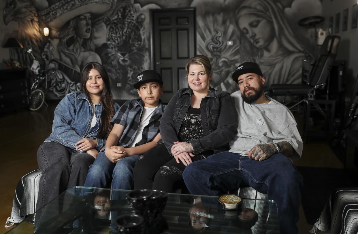 Angel Hernandez (right) poses for a portrait with his wife, Hrisanthi, and children, Karina Rojas and Guillermo Hernandez, on Wednesday, May 8, 2024, at Sugar Skull Tattoo in Bellevue, Wis.