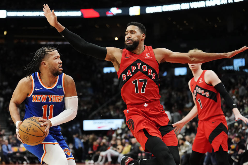 New York Knicks guard Jalen Brunson (11) looks to pass the ball as Toronto Raptors forward Garrett Temple (17) defends during the second half of an NBA basketball game Wednesday, March 27, 2024, in Toronto. (Frank Gunn/The Canadian Press via AP)