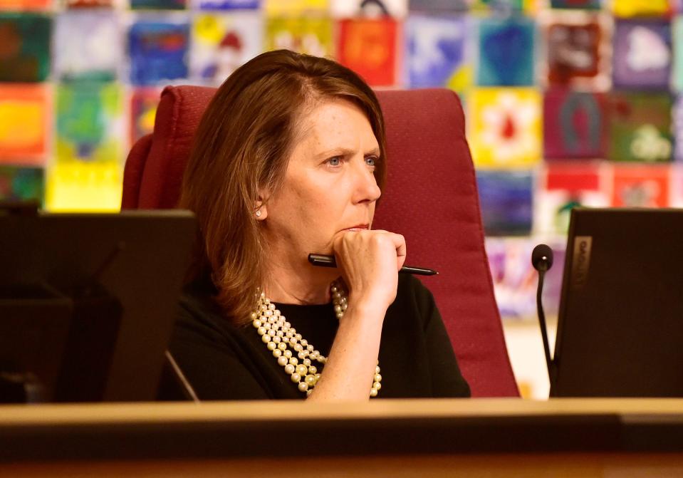 School Board Chair Kelly Coker listens to speakers at Wednesday's  meeting on the start of a legal review process.