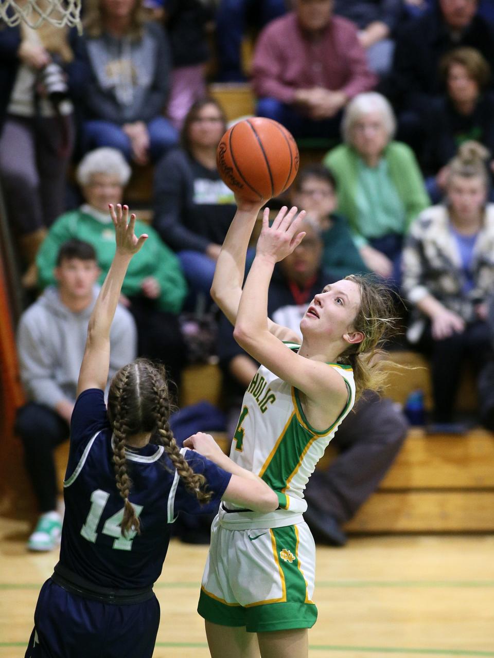 Newark Catholic's Kylie Gibson shoots a layup over Granville's Aliyah Moore on Jan. 9.