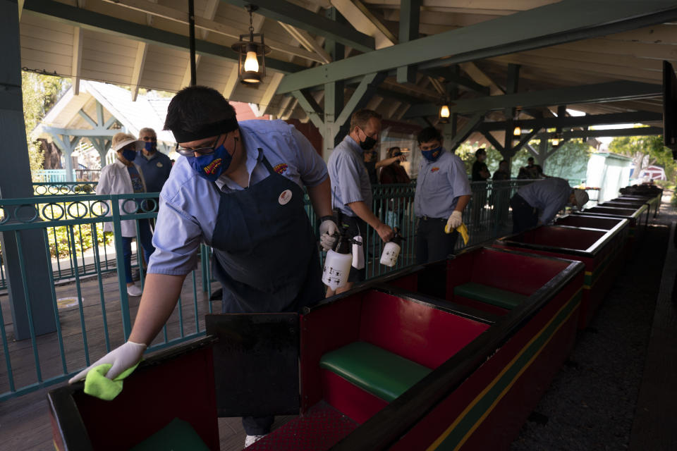 Employees disinfect a train at Adventure City amusement park on the day of reopening in Anaheim, Calif., Friday, April 16, 2021. The family-run amusement park that had been shut since March last year because of the coronavirus pandemic reopened on April 16. (AP Photo/Jae C. Hong)