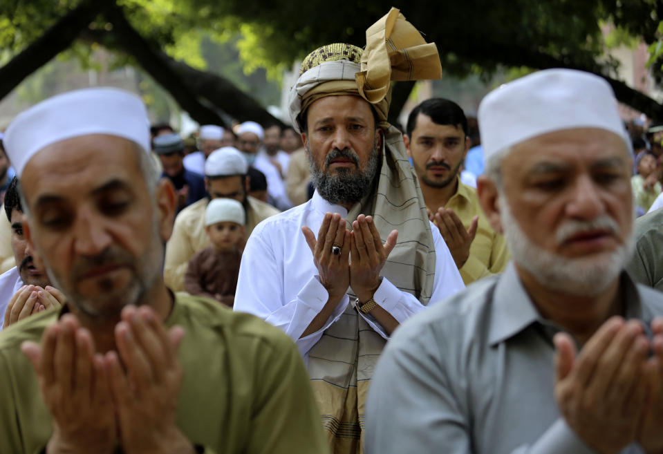 Muslims pray the Eid al-Fitr prayer, marking the end of Ramadan, Islam's holy month of fasting, in Peshawar, Pakistan, Monday, May 2, 2022. (AP Photo/Muhammad Sajjad)