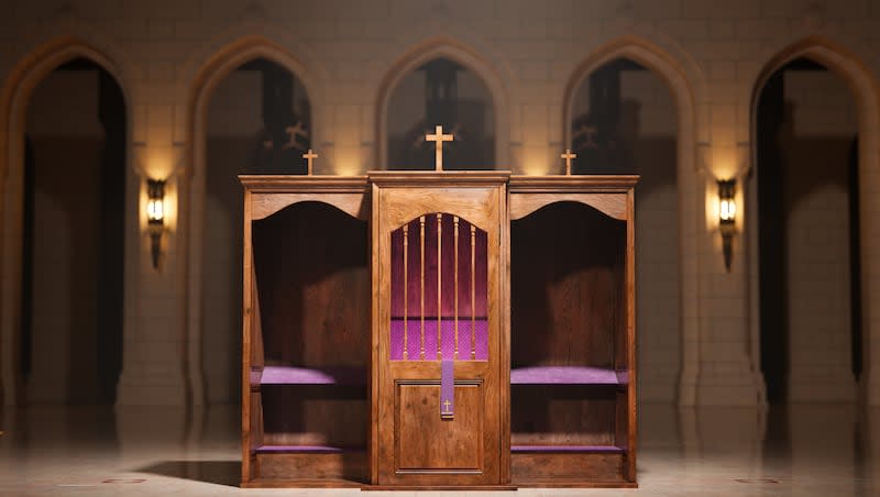 This image captures two traditional wooden confessional booths, adorned with crosses, in a church hall.