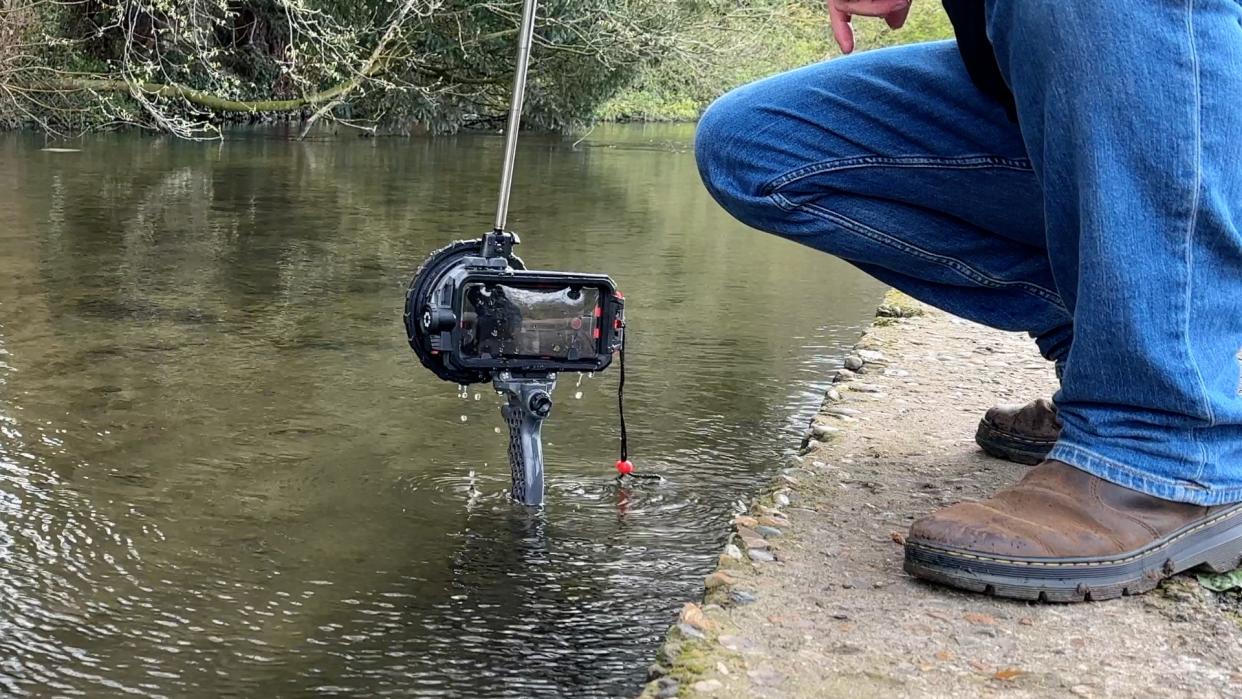  Joby SeaPal waterproof case being pulled out of a river. 