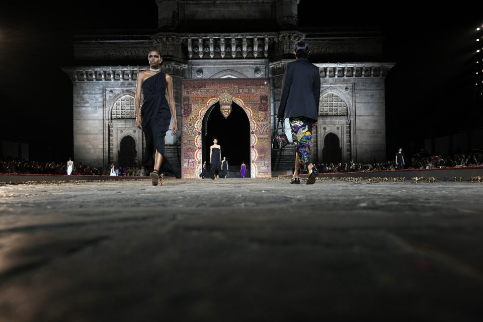 Models display creations for the Dior Pre-Fall 2023 collection at the Gateway of India landmark monument in Mumbai, India, Thursday, March 30, 2023. (AP Photo/Rafiq Maqbool)