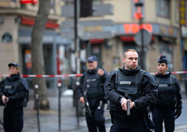 Police officers secure the area after the fatal shooting outside a police station in Paris on Thursday. Photo: AP/Christophe Ena