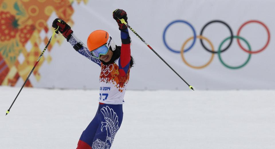 Violinst Vanessa Mae starting under her father name as Vanessa Vanakorn, celebrates in the finish area after completing the first run of the women's giant slalom at the Sochi 2014 Winter Olympics, Tuesday, Feb. 18, 2014, in Krasnaya Polyana, Russia.(AP Photo/Christophe Ena)