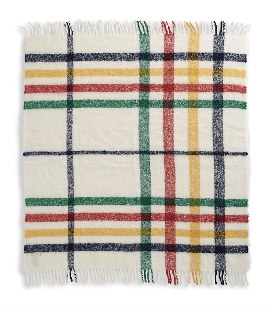 HBC Stripes Multistripe Tartan Fuzzy Throw in white, yellow, blue, red, and green tartan (Photo via The Bay)