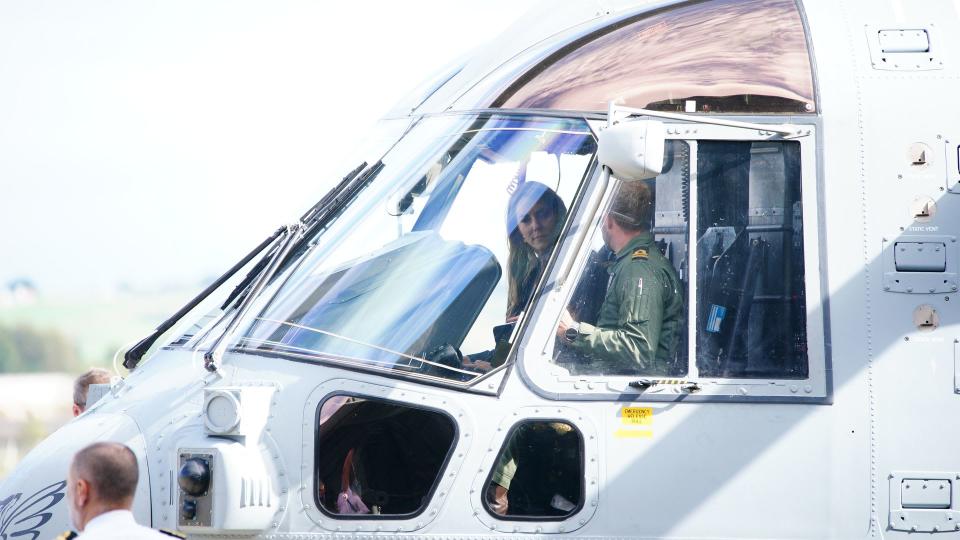 The Princess of Wales sits inside the cockpit of a Merlin Mk2 helicopter