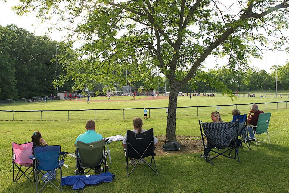 Fans watch a game between the Cubs and the Reds at Baugh Field on Monday, May 13, 2024, the opening day of Bedford Little League Tee Ball.