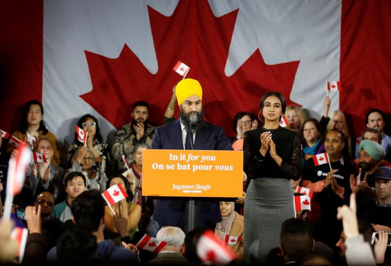 NDP leader Jagmeet Singh speaks to supporters as wife Sidhu claps after Singh was re-elected in Burnaby South at an NDP election night party in Burnaby