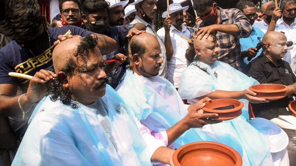 Members of Kerala Hotel and Restaurant Association shave their heads during a protest against the hike in fuel and LPG prices, outside the Indian Oil Corporation office in Kochi, Tuesday, 2 March, 2021.