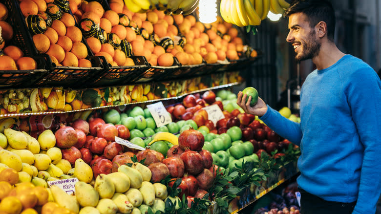 man shopping for fruit