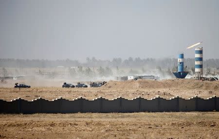 Iraqi security forces vehicles are seen in Falluja, Iraq, June 17, 2016. REUTERS/Thaier Al-Sudani