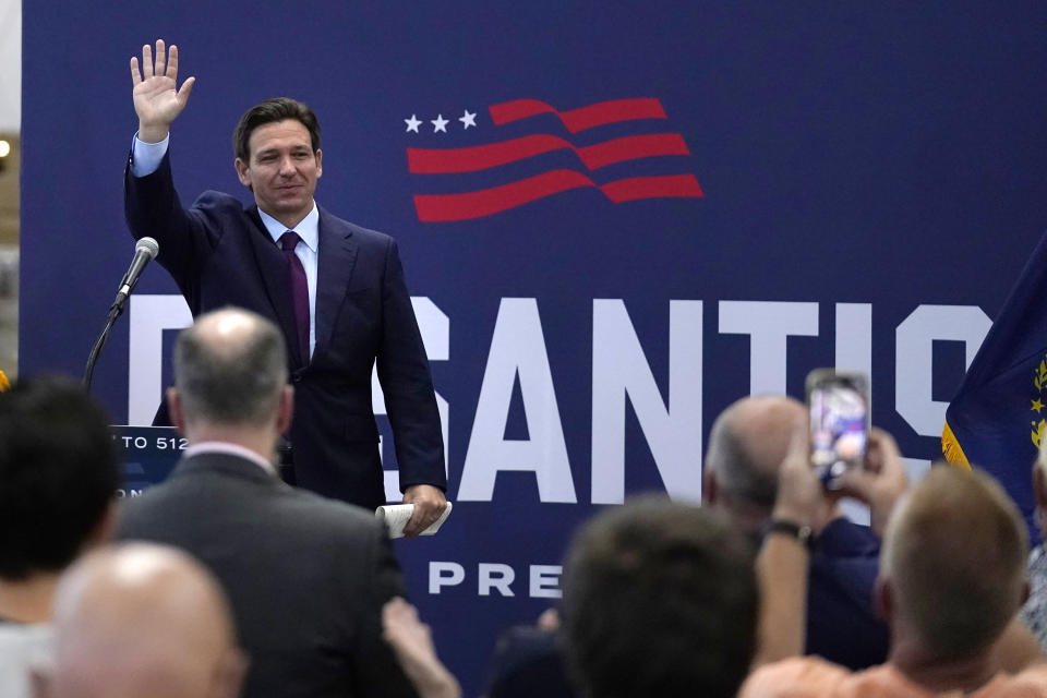 Republican presidential candidate and Florida Gov. Ron DeSantis waves to guests at a campaign event.