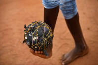 <p>A South Sudanese refugee boy plays with a ball made from plastic bags and string, on the day that much of the world watch the 2017 Champions League final, on a dirt pitch in Bidi Bidi refugee camp in northern Uganda, Saturday, June 3, 2017. Bidi Bidi is a sprawling complex of mud-brick houses that is now the world’s largest refugee settlement holding some of those who fled the civil war in South Sudan, which has killed tens of thousands and driven out more than 1.5 million people in the past three years, creating the world’s largest refugee crisis. (Photo: Ben Curtis/AP) </p>