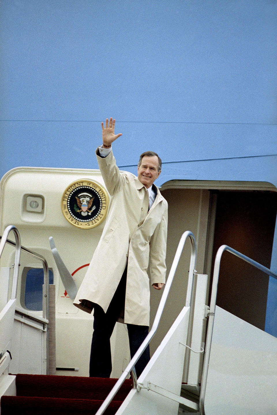 FILE - In this Feb. 19, 1992 file photo, President George H.W. Bush waves before boarding Air Force one at Andrews Air Force, Md. President Barack Obama flies Air Force One when he leaves town. So does Candidate Barack Obama. The distinction between the two roles for Obama matters because it helps determine who foots the bill for his travel. Either way, though, it's a safe bet that taxpayers are on the hook for at least part of the tab. Operating under the same rules that have governed presidential travel dating back to the Reagan years, Obama must reimburse the government for a portion of the costs associated with any political travel. But presidents of both parties have been secretive about the complicated mechanics. (AP Photo/Charles Tasnadi, File)