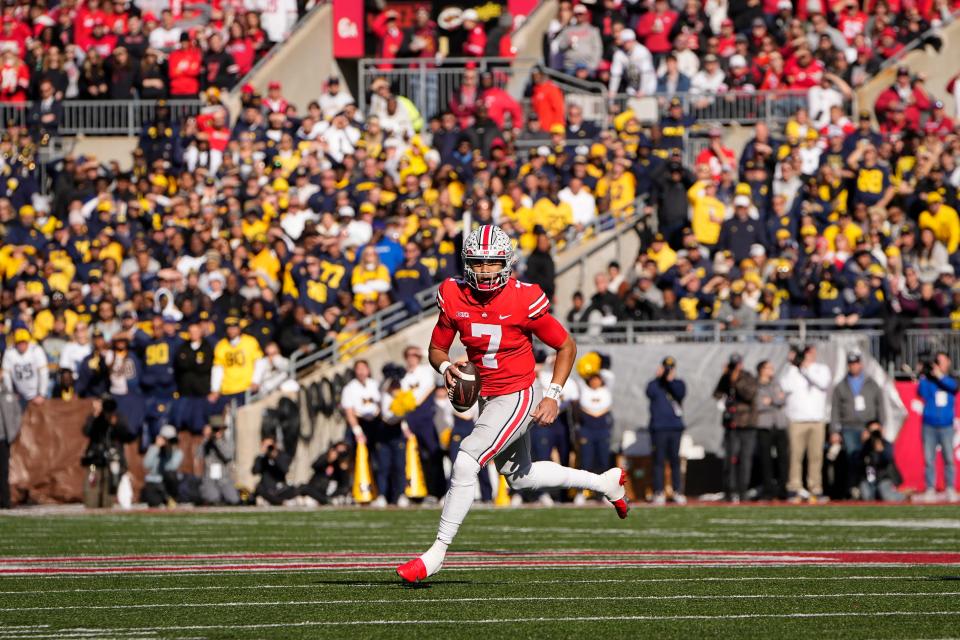 Nov 26, 2022; Columbus, Ohio, USA;  Ohio State Buckeyes quarterback C.J. Stroud (7) scrambles out of the pocket during the first half of the NCAA football game against the Michigan Wolverines at Ohio Stadium. Mandatory Credit: Adam Cairns-The Columbus Dispatch