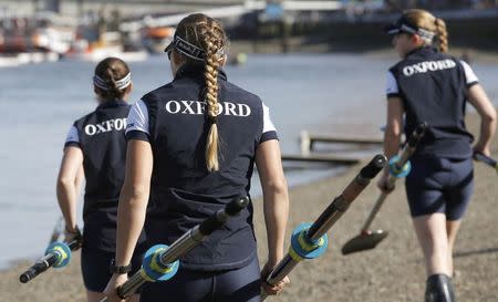 Members of the Oxford women's crew prepare to take to the water before the Oxford versus Cambridge University boat race on the Thames in London, April 11. 2015. REUTERS/Peter Nicholls