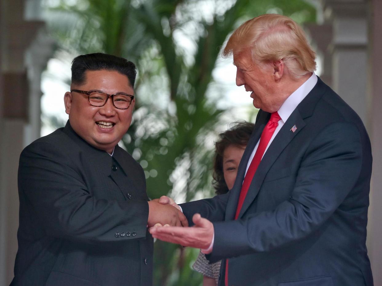 North Korean leader Kim Jong-un shakes hands with US President Donald Trump during their historic US-DPRK summit: Getty