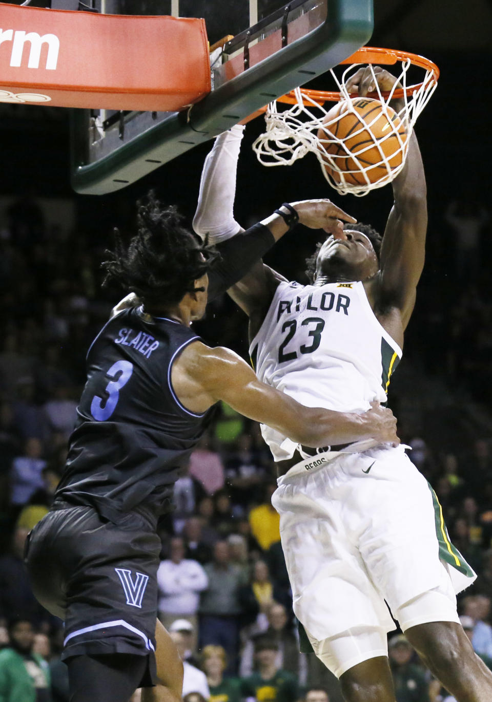 Baylor forward Jonathan Tchamwa Tchatchoua (23) goes up for the dunk as Villanova forward Brandon Slater (3) defends during the second half of an NCAA college basketball game on Sunday, Dec. 12, 2021, in Waco, Texas. (AP Photo/Ray Carlin)