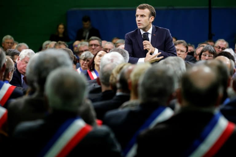 French President Emmanuel Macron addresses a gathering some 600 mayors who relayed the concerns aired by residents in their towns and villages