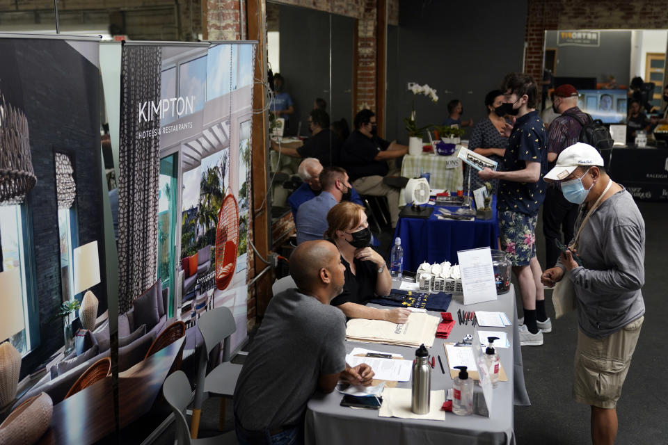 FILE - Prospective employers and job seekers interact during during a job fair on Sept. 22, 2021, in the West Hollywood section of Los Angeles. California's unemployment rate dipped a half-percentage point in December as the most populous state added 50,700 nonfarm jobs, accounting for more than a quarter of the nation's 199,000 job growth for the month, according to new data released Friday, Jan. 21, 2022. (AP Photo/Marcio Jose Sanchez, File)