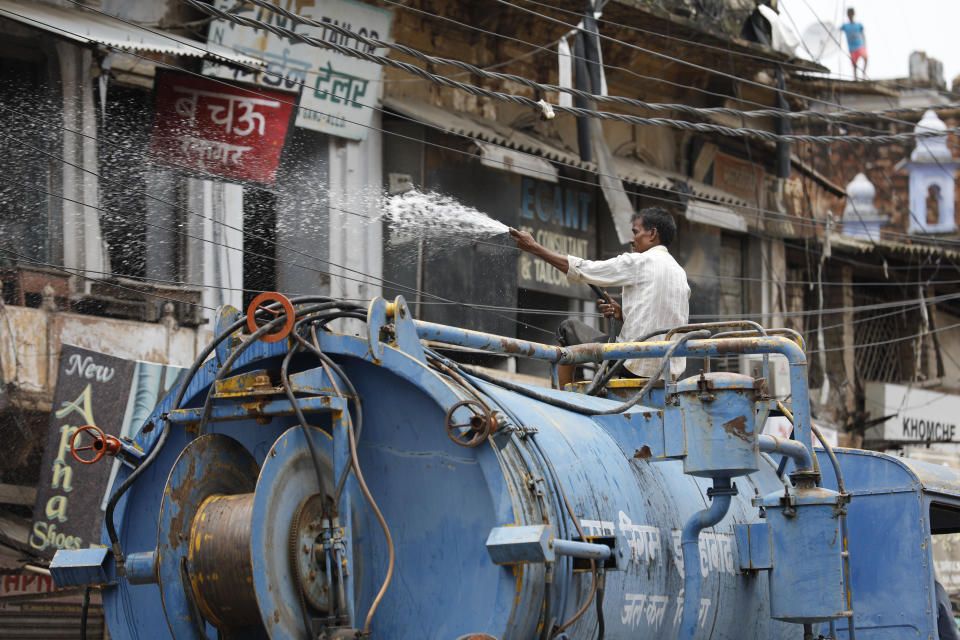 A municipal worker disinfects an area amid rising COVID-19 cases in Prayagraj, India, Saturday, July 11, 2020. In just three weeks, India went from the world’s sixth worst-affected country by the coronavirus to the third, according to a tally by Johns Hopkins University. India's fragile health system was bolstered during a stringent monthslong lockdown but could still be overwhelmed by an exponential rise in infections. (AP Photo/Rajesh Kumar Singh)