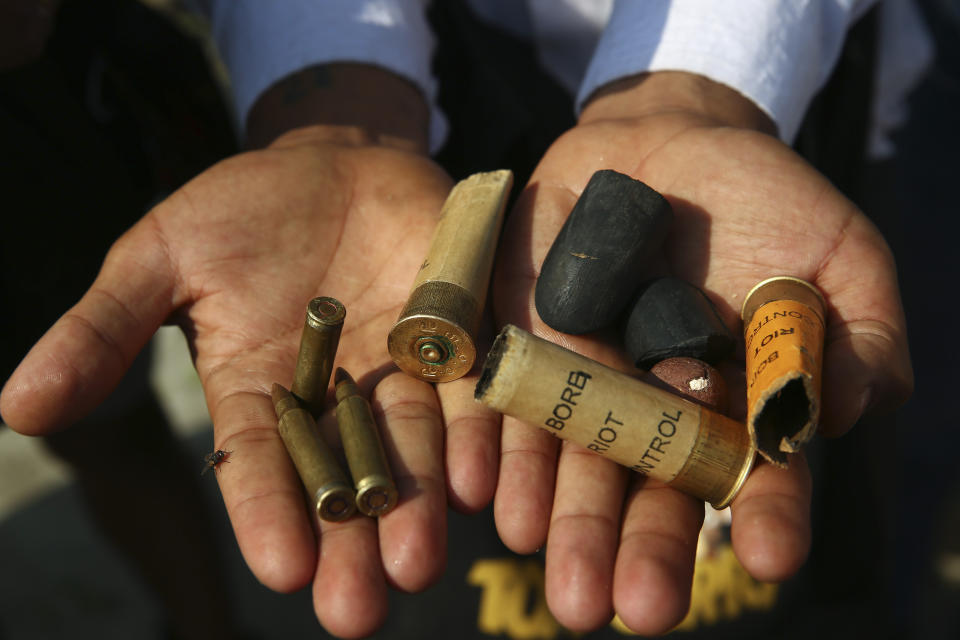 A protester show bullets, shotgun shells and rubber bullets used by security forces during a demonstration against the military coup in Mandalay, Myanmar, Friday, Feb. 26, 2021. (AP Photo)