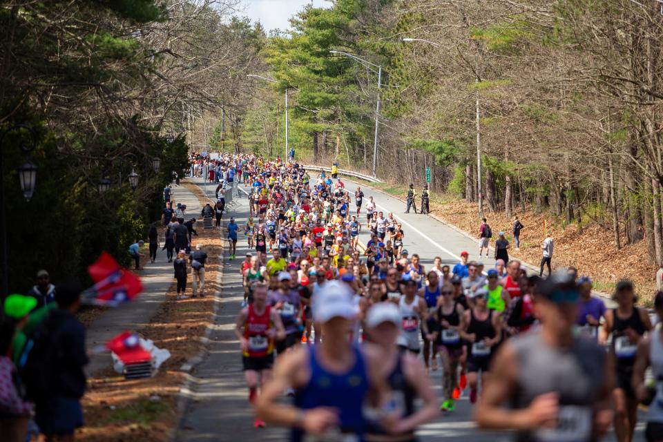 Runners along the course in Wellesley during 128th running of the Boston Marathon, in front of Wellesley College, April 15, 2024.