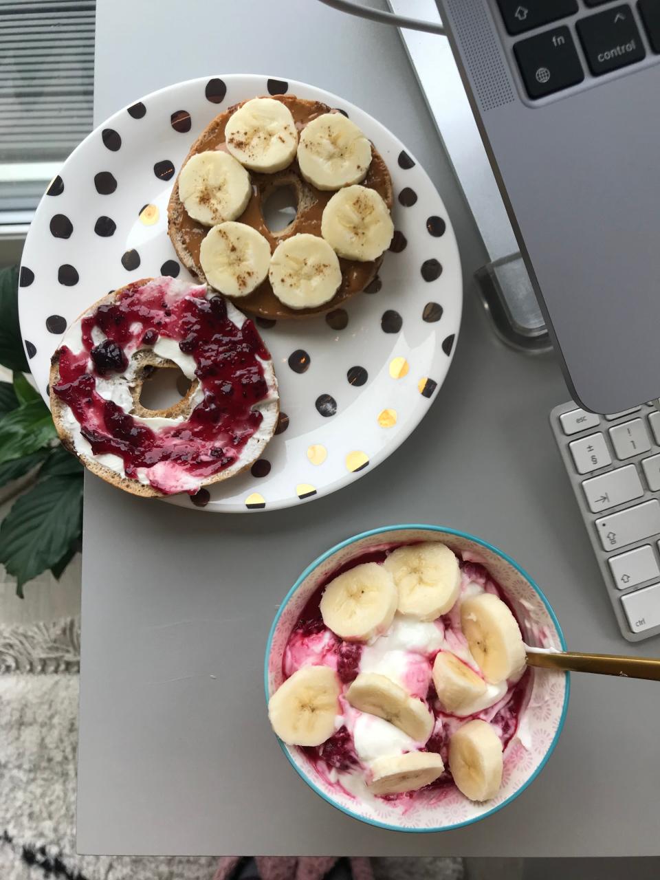 A bagel with yogurt on the side.