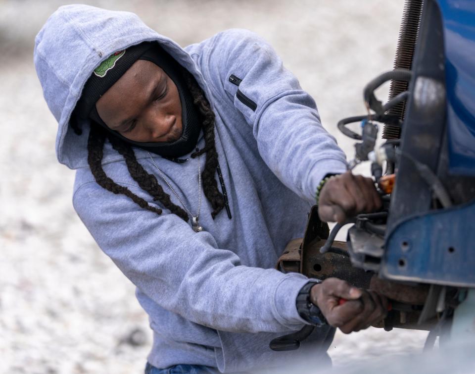 Prindell Young, Indianapolis, works at removing the support for a radiator off a vehicle in the Martindale-Brightwood neighborhood of Indianapolis, Tuesday, March 7, 2023, at Pull-A-Part, a national chain of do-it-yourself auto salvage facilities.