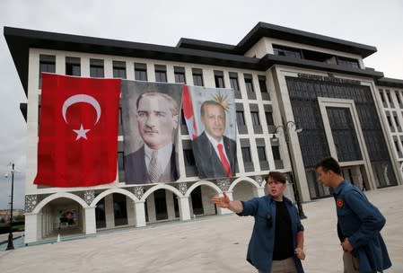 Sancaktepe Municipality building is decorated with a Turkish flag and pictures of modern Turkey's founder Ataturk and Turkish President Tayyip Erdogan during a ceremony in Istanbul