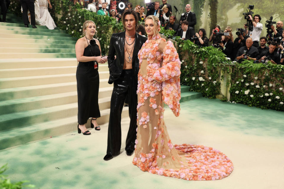 Kelsea in a floral-embellished sheer gown, Chase in a sequined suit