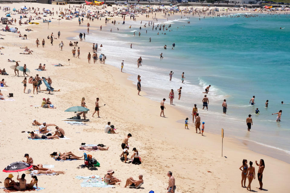 People gather on Bondi Beach as they celebrate Christmas in Sydney, enjoying the hot weather