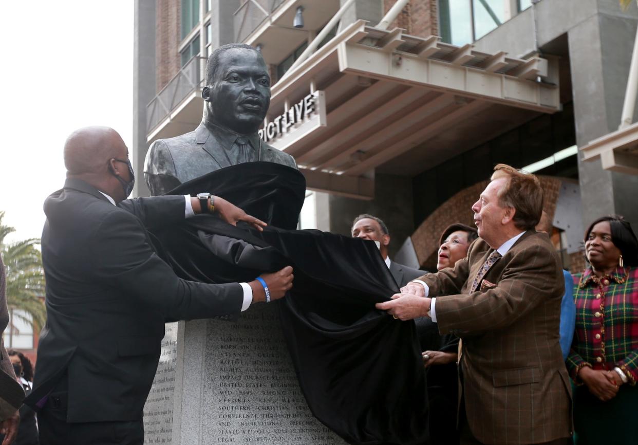 Savannah Mayor Van Johnson and Richard Kessler, president and CEO of the Kessler Collection, unveil the Martin Luther King, Jr bust on Saturday during a ceremony at Plant Riverside District.