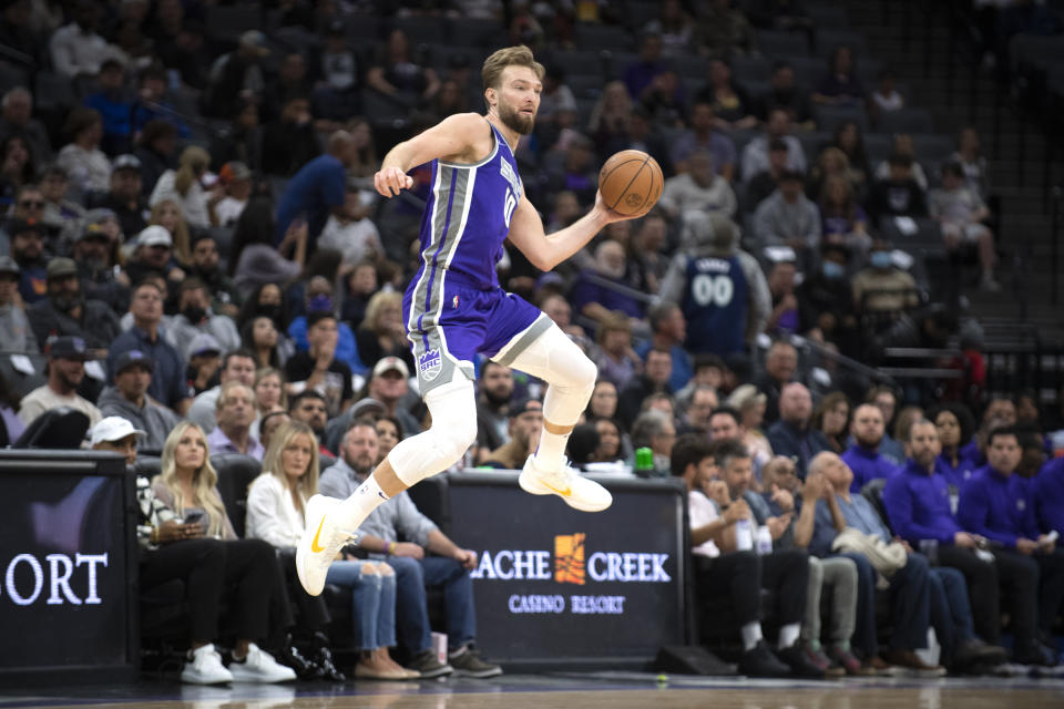 Sacramento Kings forward Domantas Sabonis (10) saves a ball from going into the backcourt in the first quarter of an NBA basketball game against the Phoenix Suns in Sacramento, Calif., Sunday, March 20, 2022. (AP Photo/José Luis Villegas)