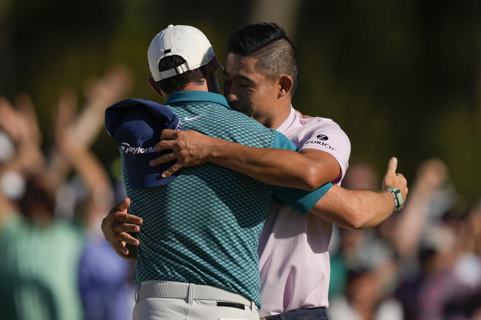 Collin Morikawa, right, hugs Rory McIlroy, of Northern Ireland, after they both holed out for a birdie on the 18th hole during the final round at the Masters golf tournament on Sunday, April 10, 2022, in Augusta, Ga. (AP Photo/Matt Slocum)