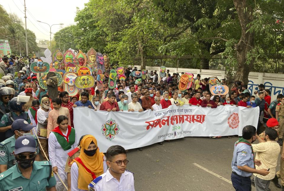 People walk in a procession to mark the Bengali New Year in Dhaka, Bangladesh, Wednesday, April 14, 2022. After a two-year break, thousands of people in Bangladesh and Nepal on Thursday celebrated their respective new years with colorful processions and musical soirees as the coronavirus pandemic eased and life swung back to normal. (AP Photo/Al Emrun Garjon)