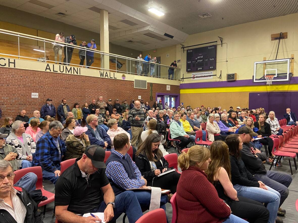 About 100 people filled the gym at McAdam High School to directly tell senior RCMP officials about the concerns they have with the quality of policing. (Aidan Cox/CBC - image credit)