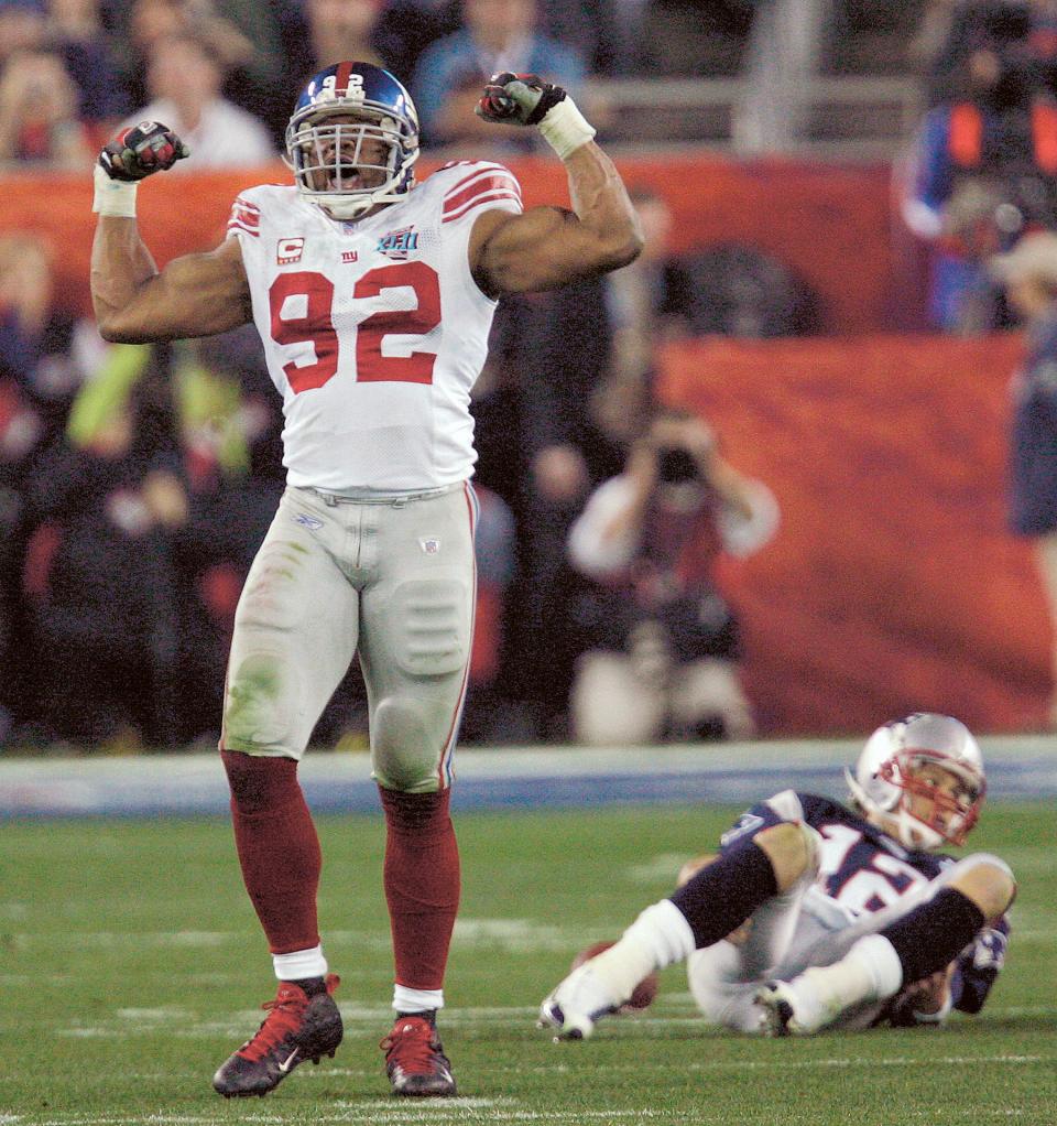 New York Giants defensive end Michael Strahan (92) reacts after sacking New England Patriots quarterback Tom Brady (12) in the third quarter during the Super Bowl XLII football game at University of Phoenix Stadium on Sunday, Feb. 3, 2008 in Glendale, Ariz. (AP Photo/David Duprey)