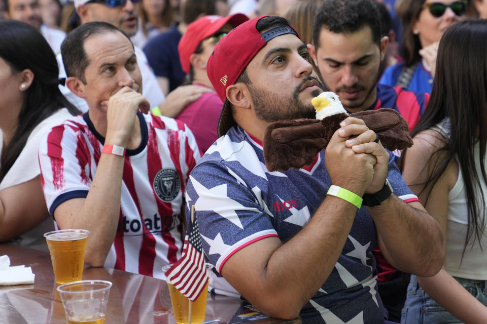 Victor Riobueno holds a stuffed toy eagle as he watches a World Cup round of 16 soccer match between the Netherlands and the United States at the Fritz & Franz Bierhaus, Saturday, Dec. 3, 2022, in Coral Gables, Fla. The Netherlands won 3-1. (AP Photo/Lynne Sladky)