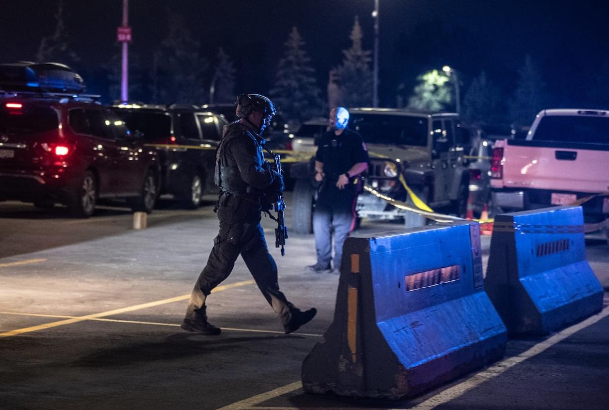 Police investigate the scene of a multiple shooting at West Edmonton Mall in Edmonton. The mall was on lockdown Monday night after multiple reports of a shooting.   (Jason Franson/The Canadian Press - image credit)