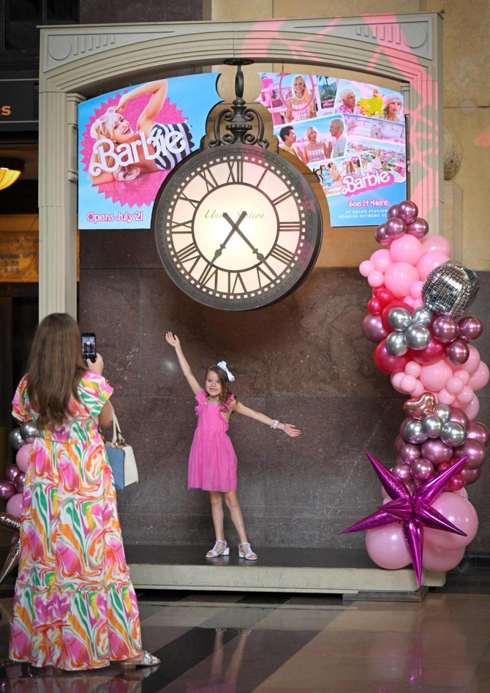 Opal Stevens of Merriam photographed her daughter, Pearl Stephens, 7, in a Barbie display during a visit to the Barbie-themed displays Thursday at Union Station. Tammy Ljungblad/tljungblad@kcstar.com