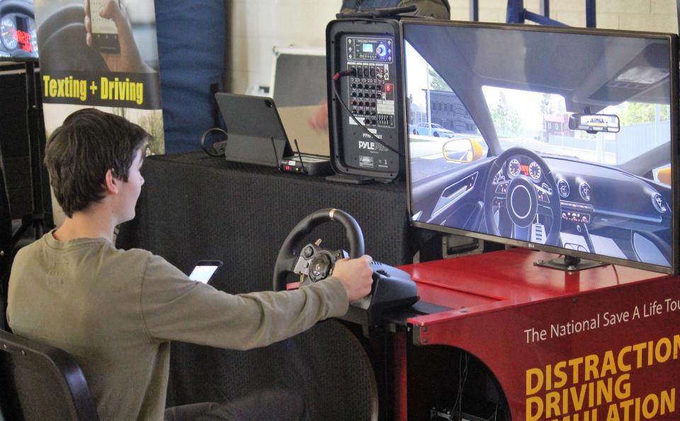 A student at Holland Christian High School uses a driving simulator while texting to see firsthand the dangers of distracted driving.