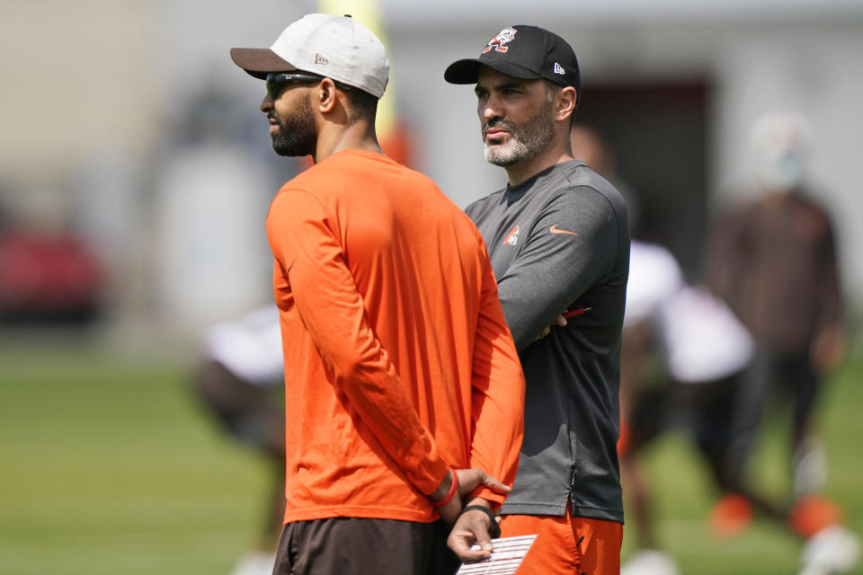 General manager and executive vice president of football operations Andrew Berry, left, and head coach Kevin Stafanski watch during an NFL football rookie minicamp at the team's training camp facility, Friday, May 14, 2021, in Berea, Ohio. (AP Photo/Tony Dejak)